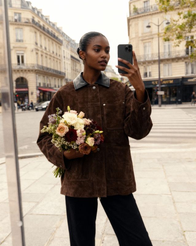 a woman taking a picture of herself with her cell phone