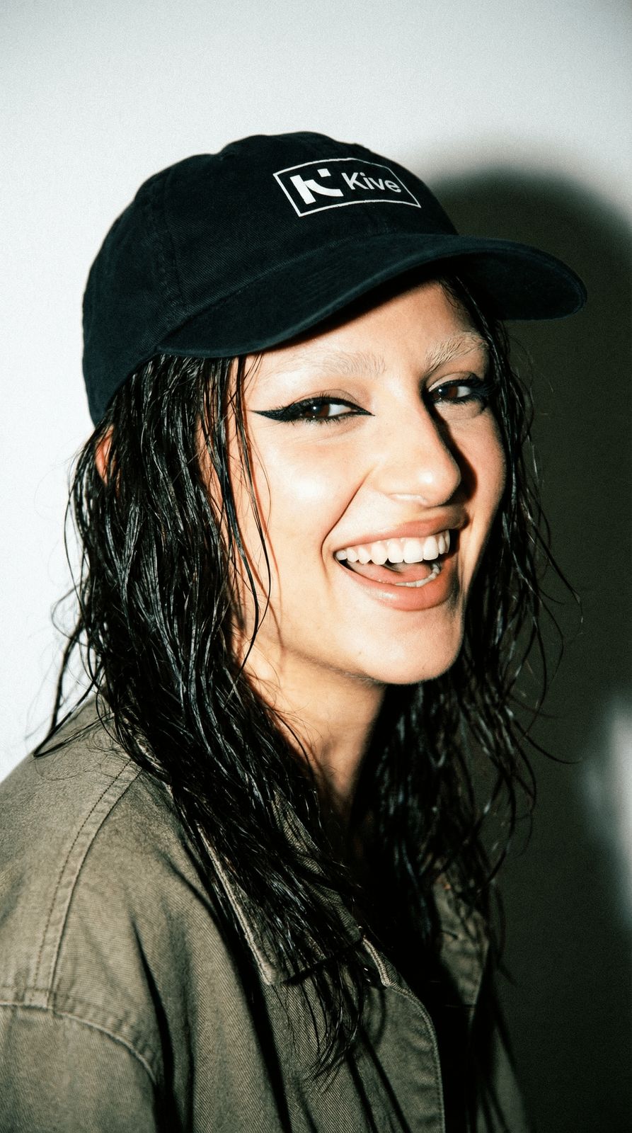 a woman with long hair wearing a black hat