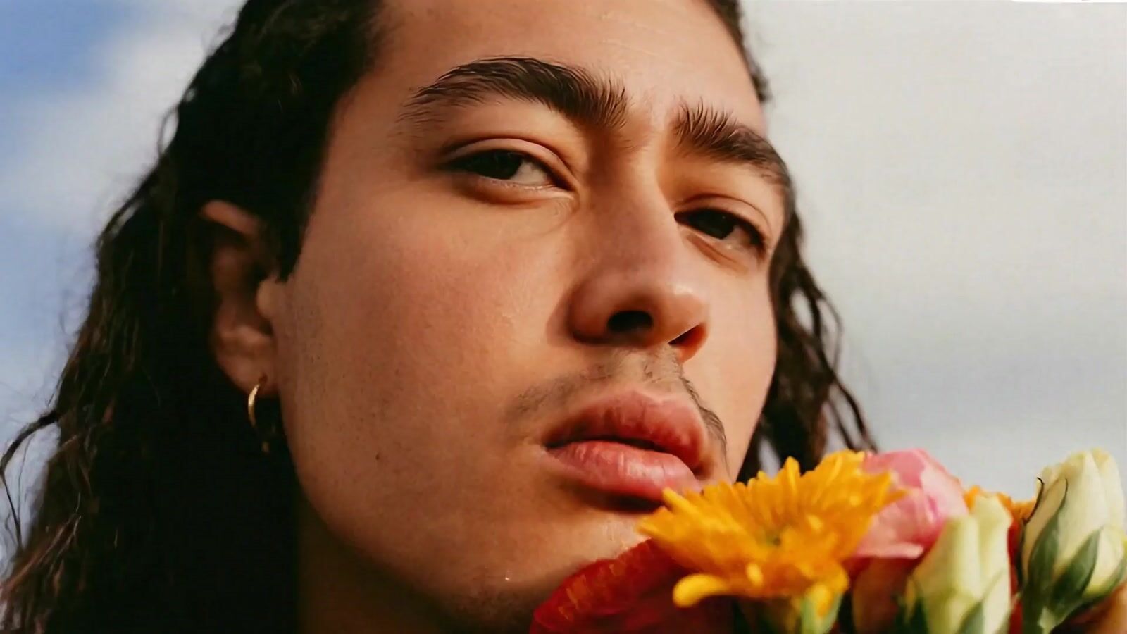 a close up of a person holding a flower