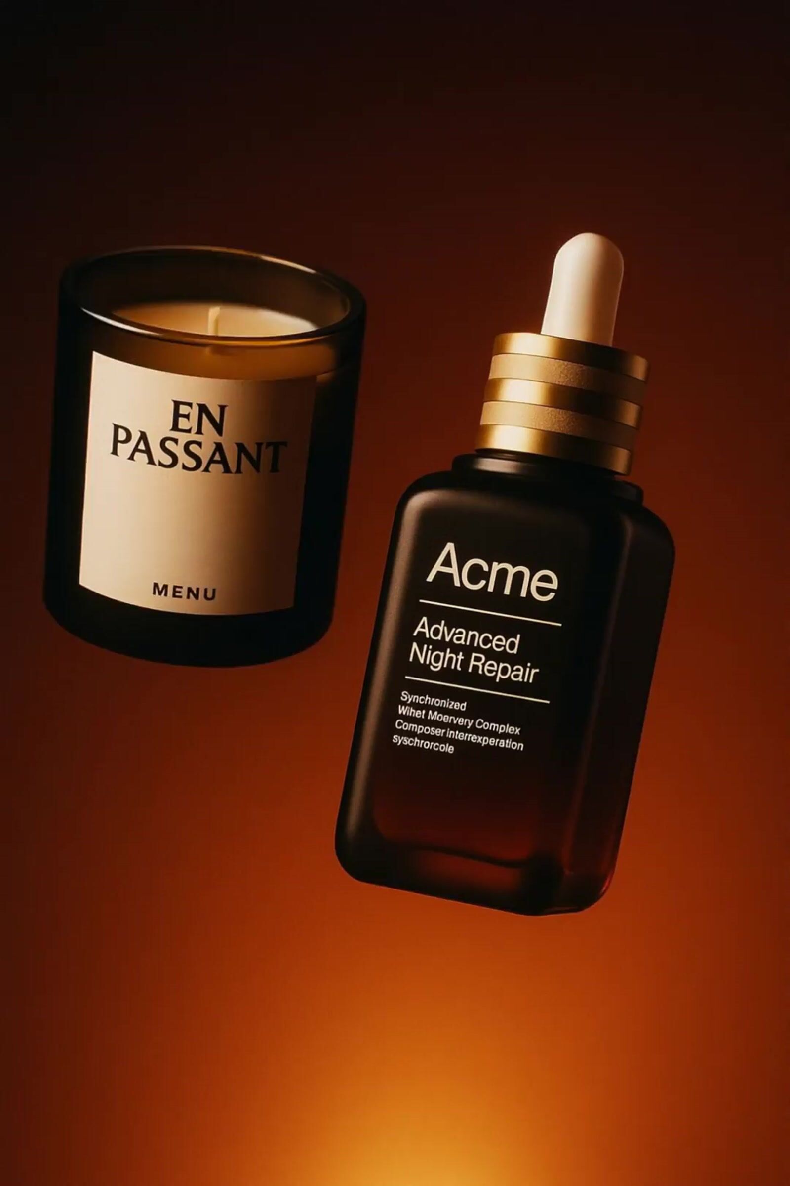 a bottle of acne advanced night repair next to a candle