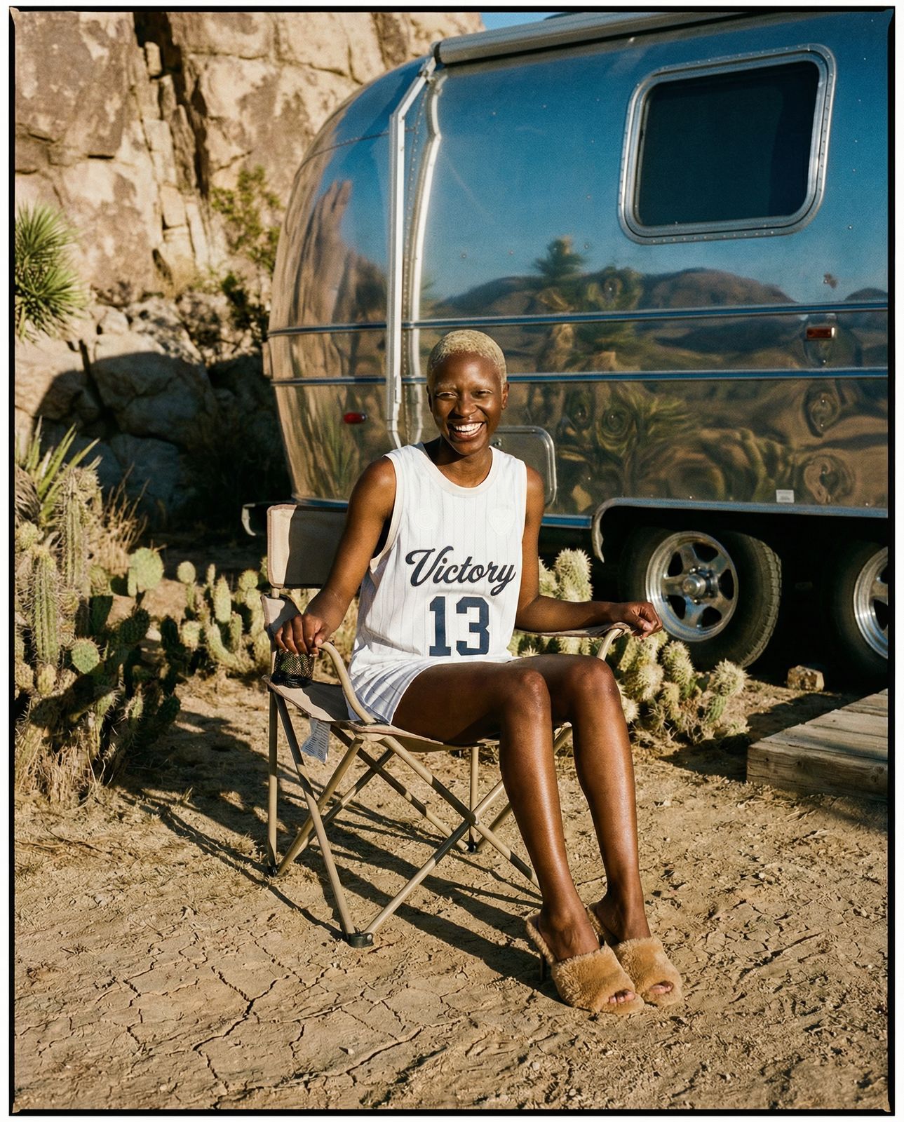 a woman sitting in a chair in front of a trailer