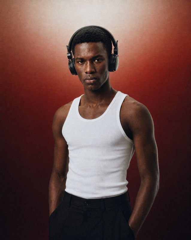 a man wearing headphones and a tank top