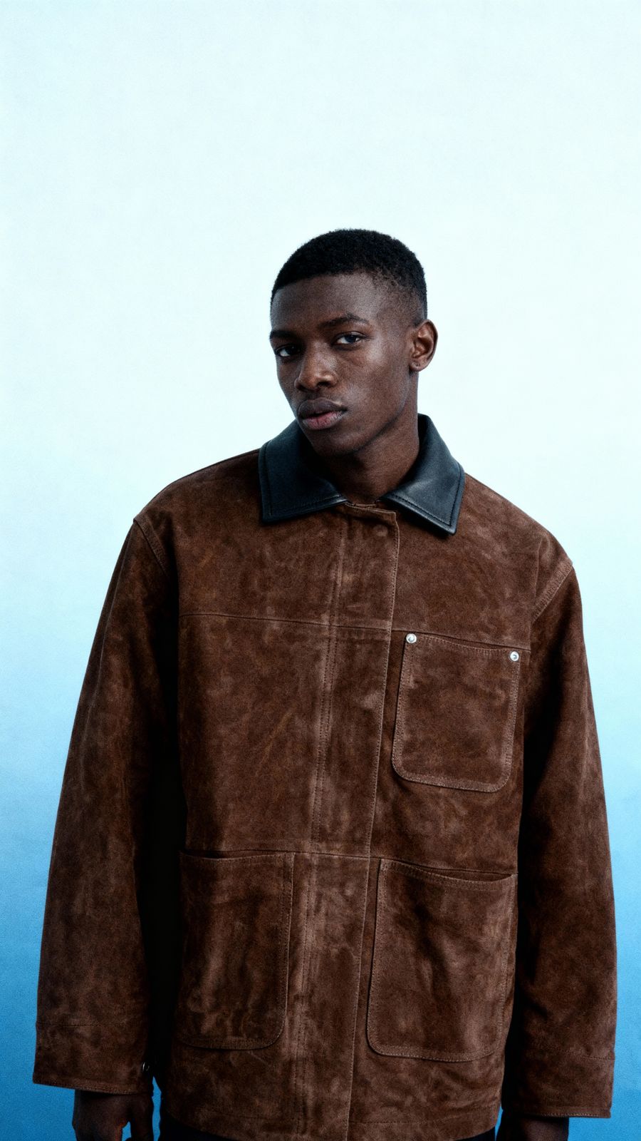 a man standing in front of a blue background