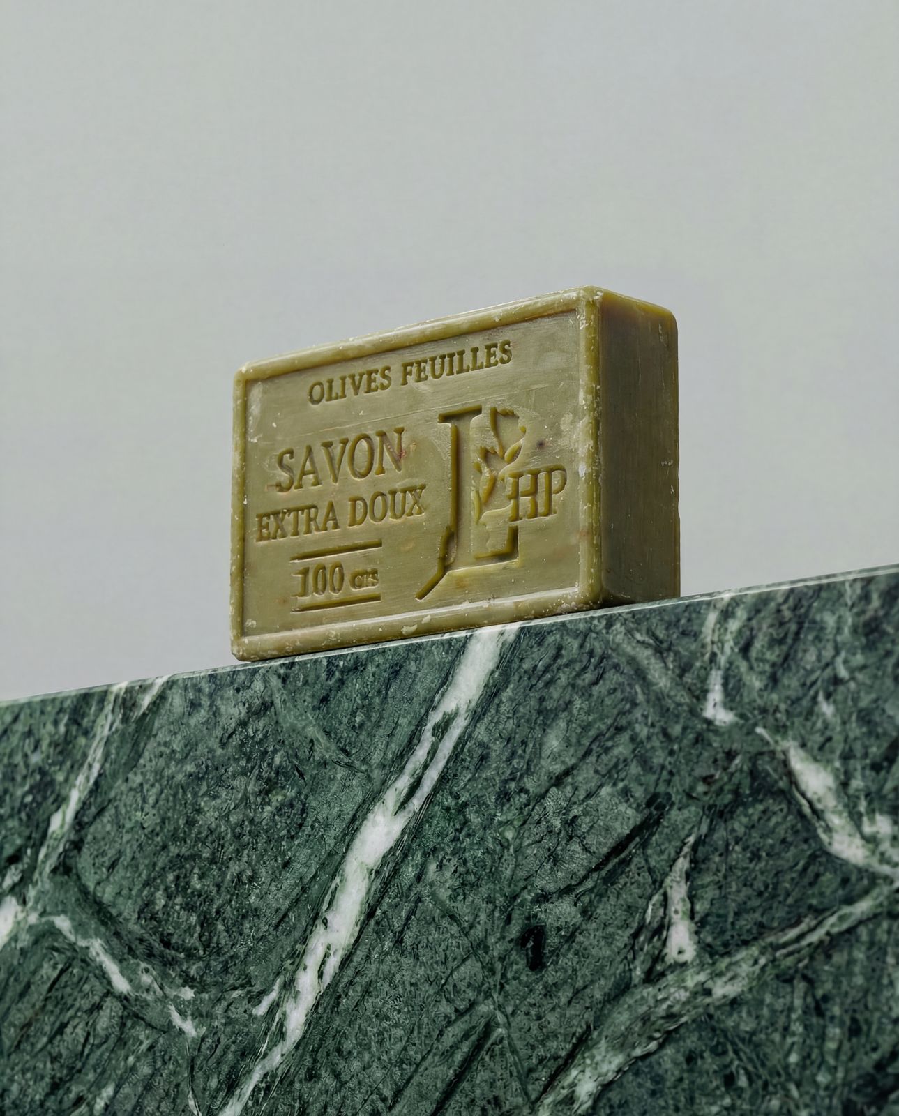 a bar of soap sitting on top of a marble counter