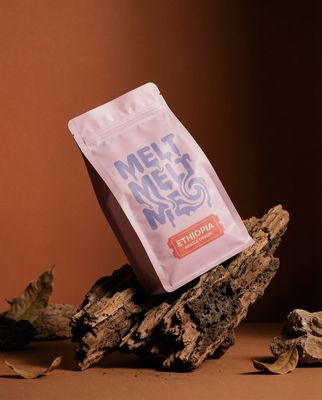 a bag of coffee sitting on top of a pile of wood