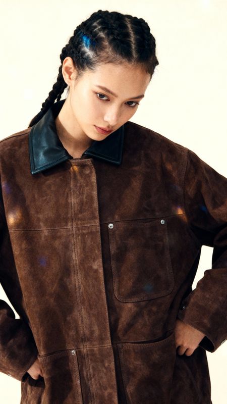 a woman wearing a brown jacket and a black bow tie