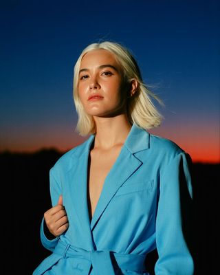 a woman with blonde hair wearing a blue suit