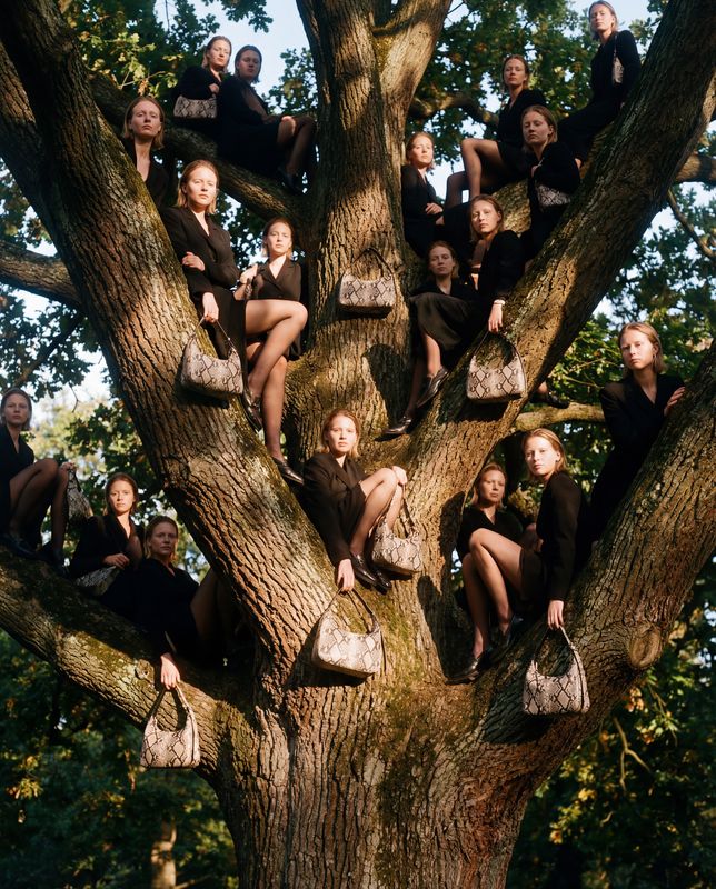 a group of women sitting in the branches of a tree