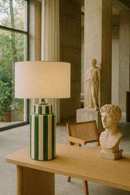 a table with a lamp and a statue on it