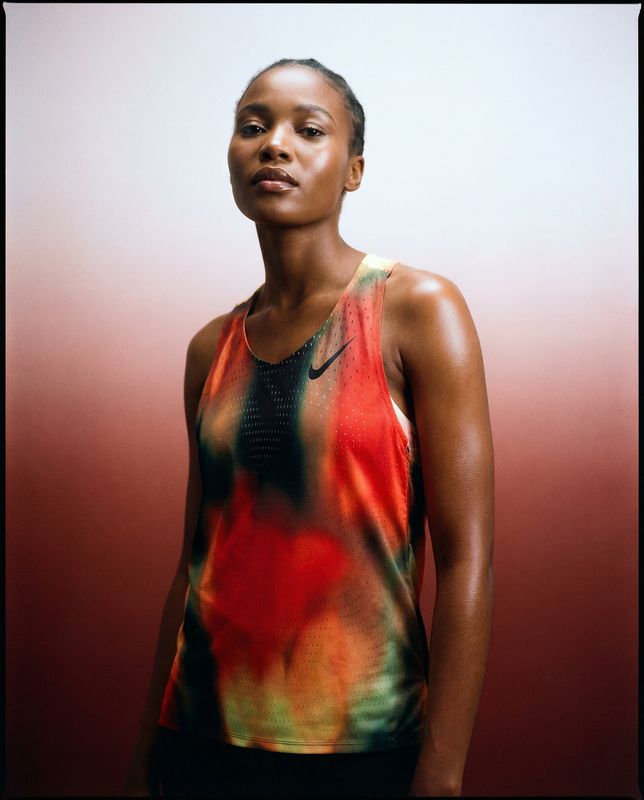a woman in a tank top posing for a picture