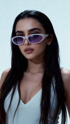 a woman wearing a white tank top and purple sunglasses