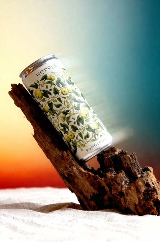 a can of tea sitting on top of a piece of wood