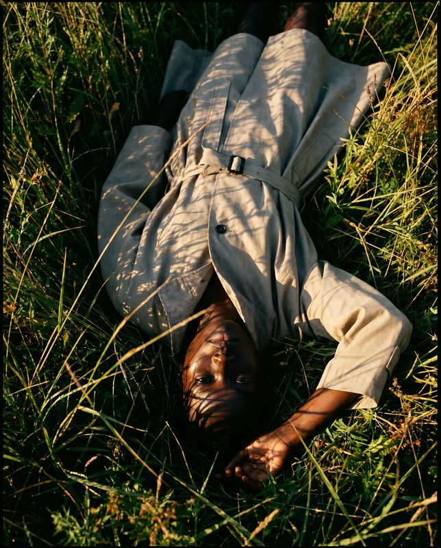 a person laying on the ground in the grass