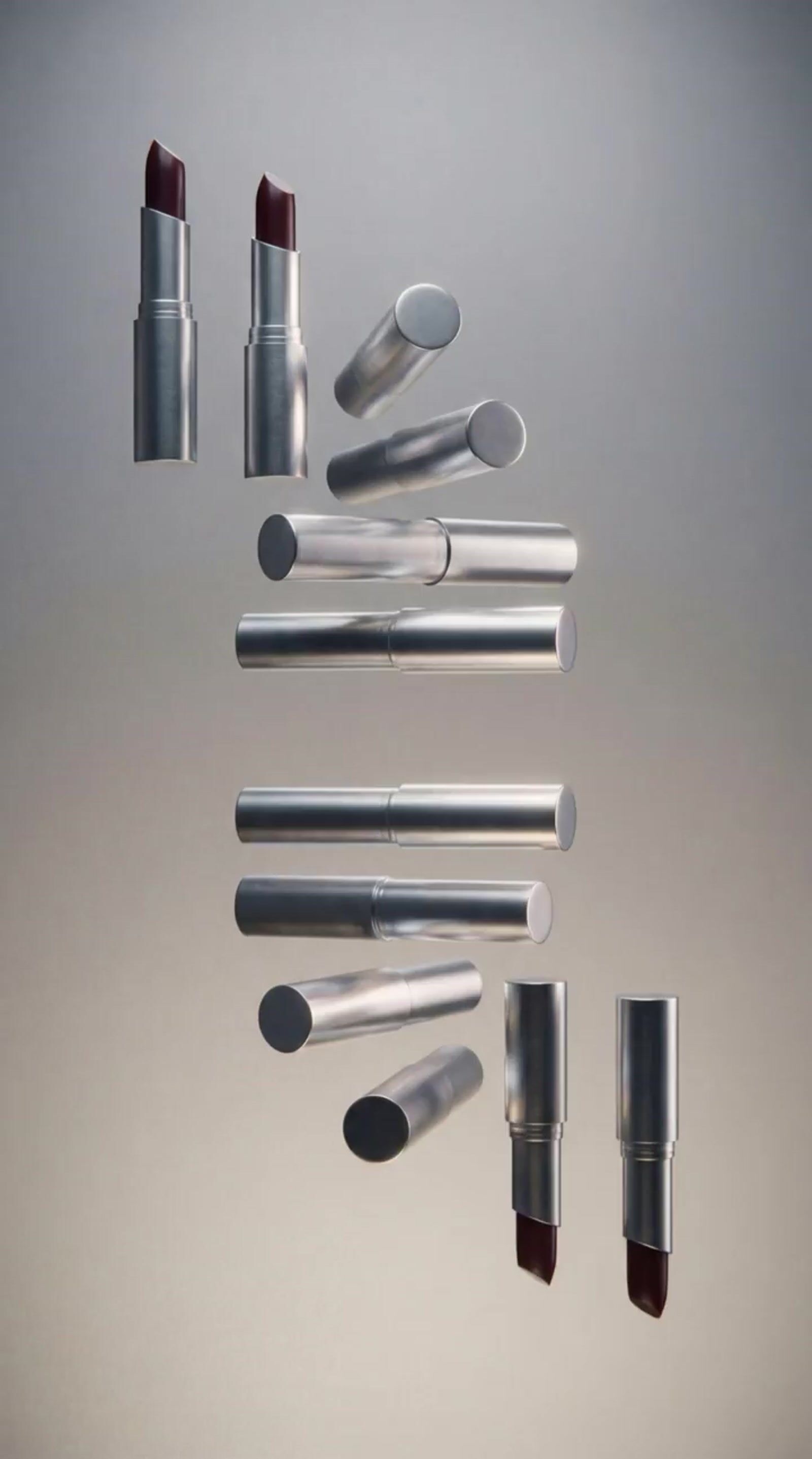 a group of different types of lipstick on a gray background