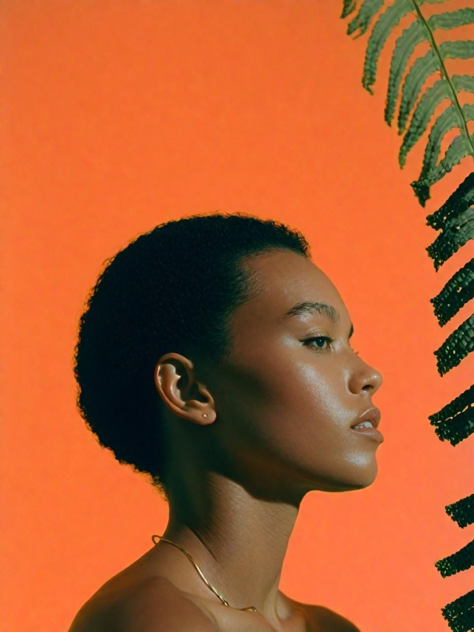 a woman standing in front of a palm tree