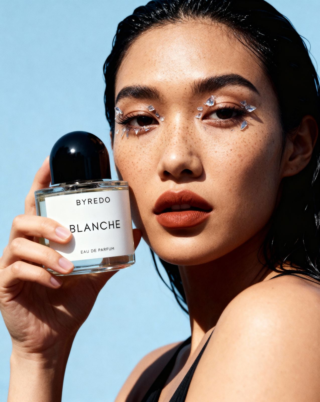 a woman holding a bottle of blvded blanche