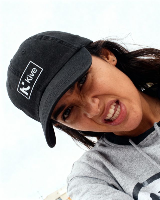 a woman wearing a black hat and a gray sweatshirt