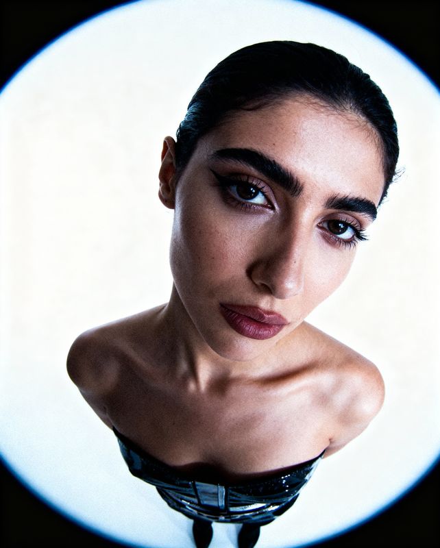 a woman in a black dress with her eyes closed