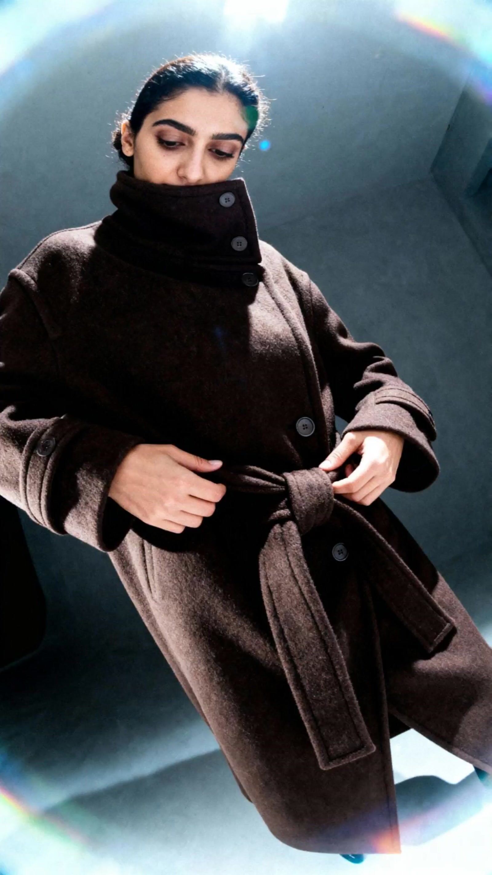 a woman wearing a coat and a scarf