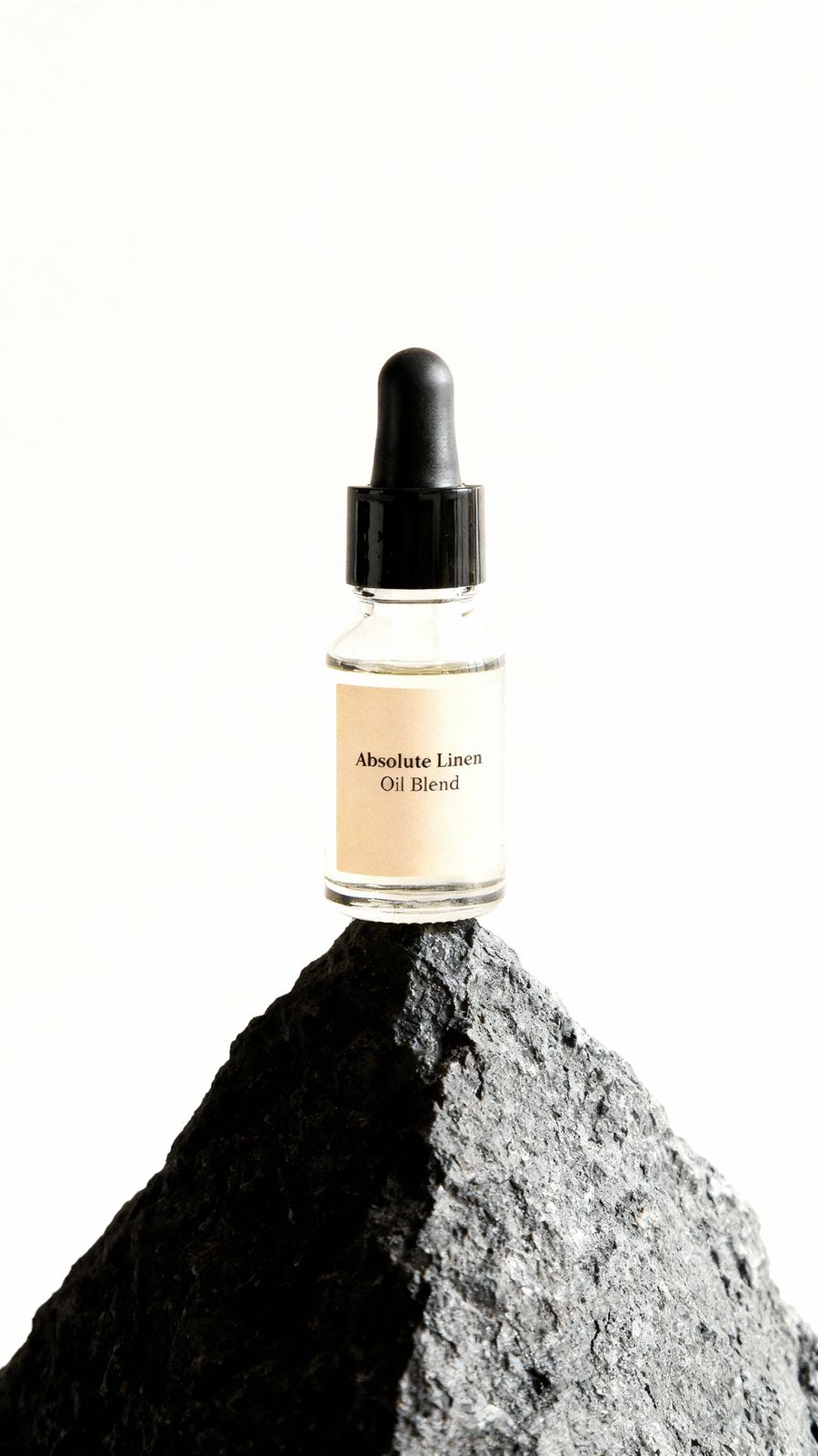 a bottle of cologne sitting on top of a rock