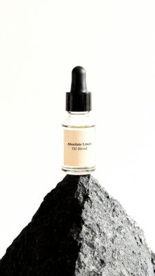 a bottle of cologne sitting on top of a rock