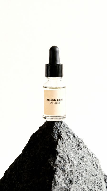 a bottle of cologne sitting on top of a rock