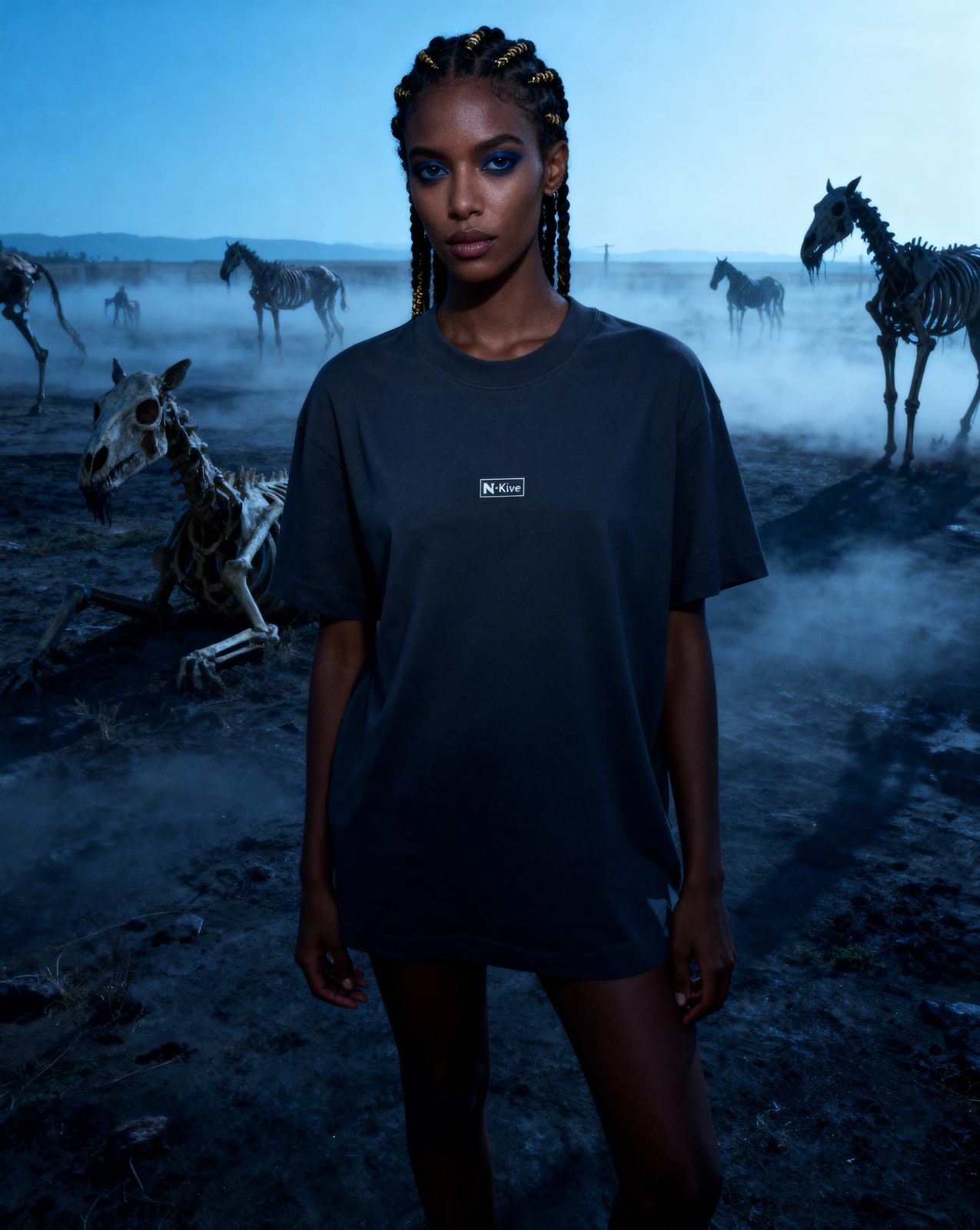 a woman standing in front of a herd of zebras