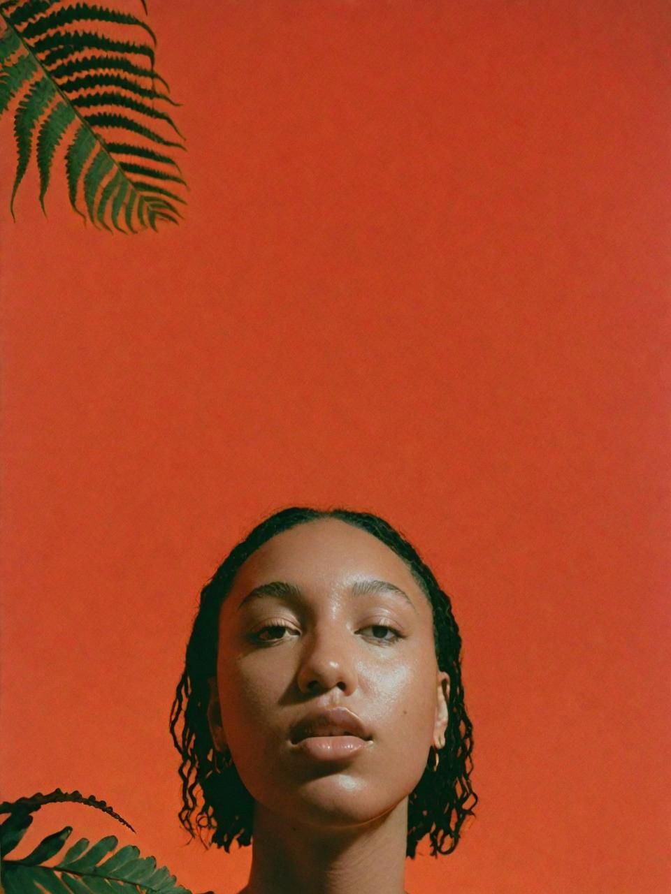 a woman standing in front of a red wall