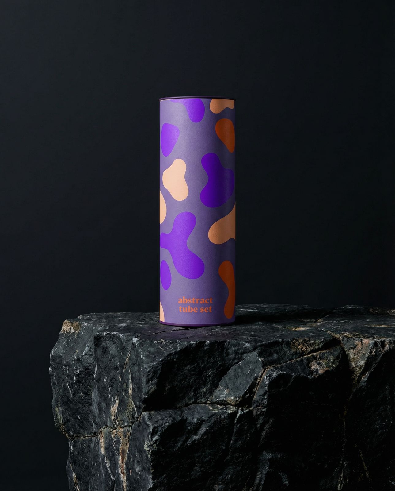 a purple and orange cup sitting on top of a rock