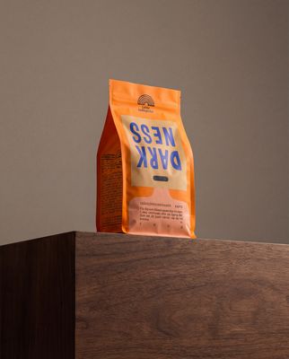 a bag of coffee sitting on top of a wooden table