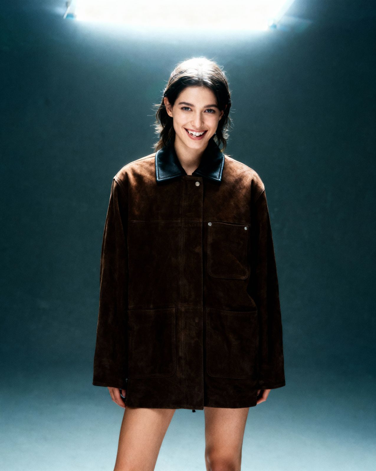 a woman standing in front of a spotlight