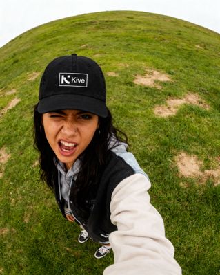 a woman wearing a black hat and a black and white jacket