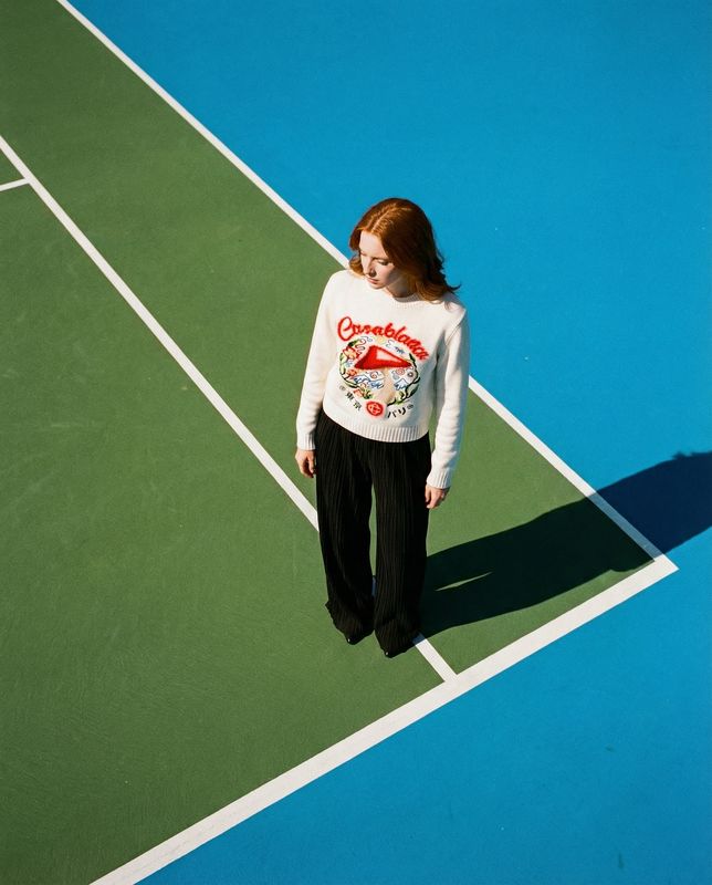 a woman is standing on a tennis court
