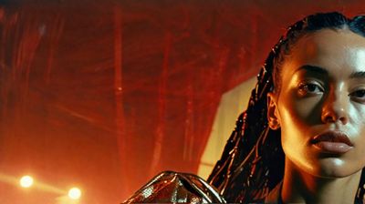 a woman with dreadlocks standing in front of a stage