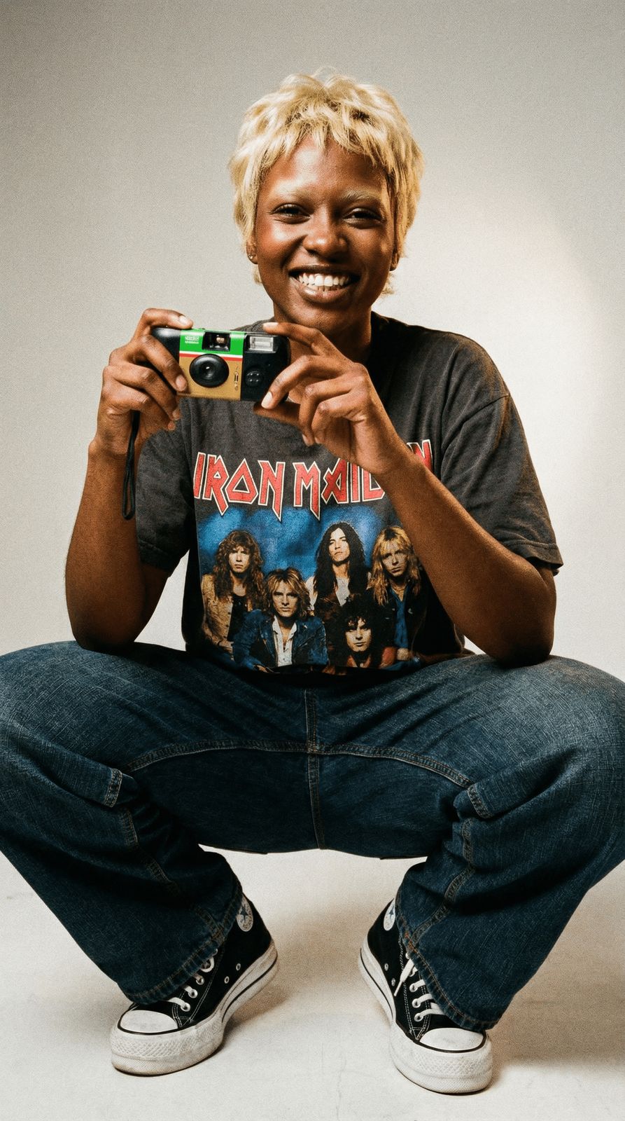 a man sitting on the ground holding a camera