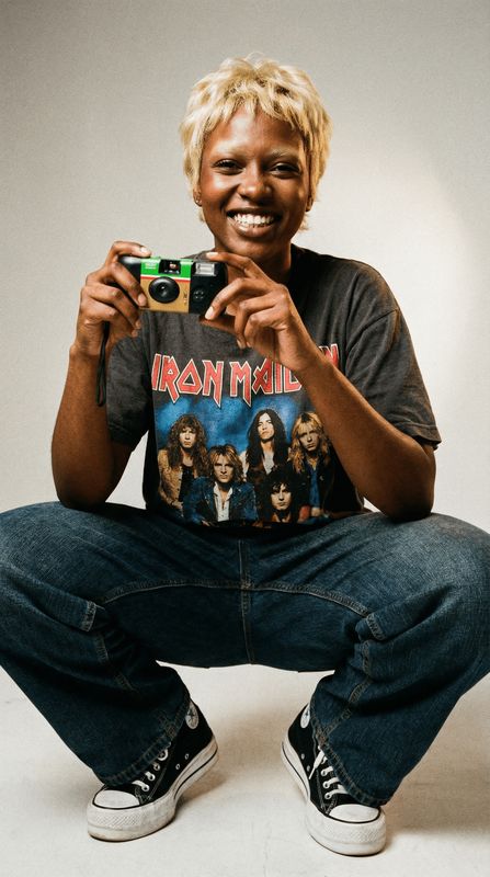 a man sitting on the ground holding a camera