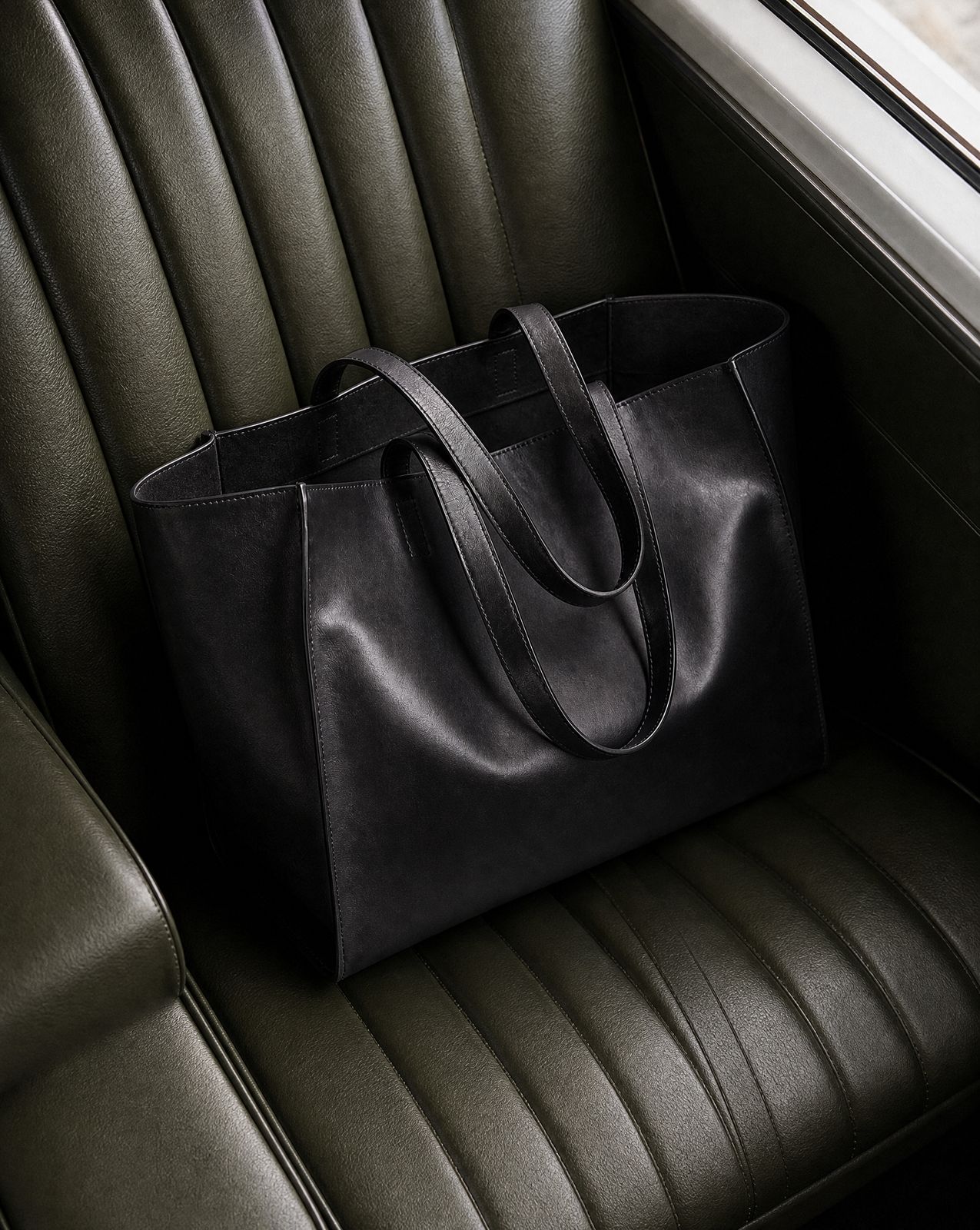 a black bag sitting on top of a green chair