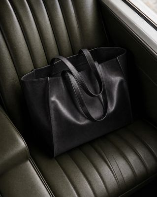 a black bag sitting on top of a green chair