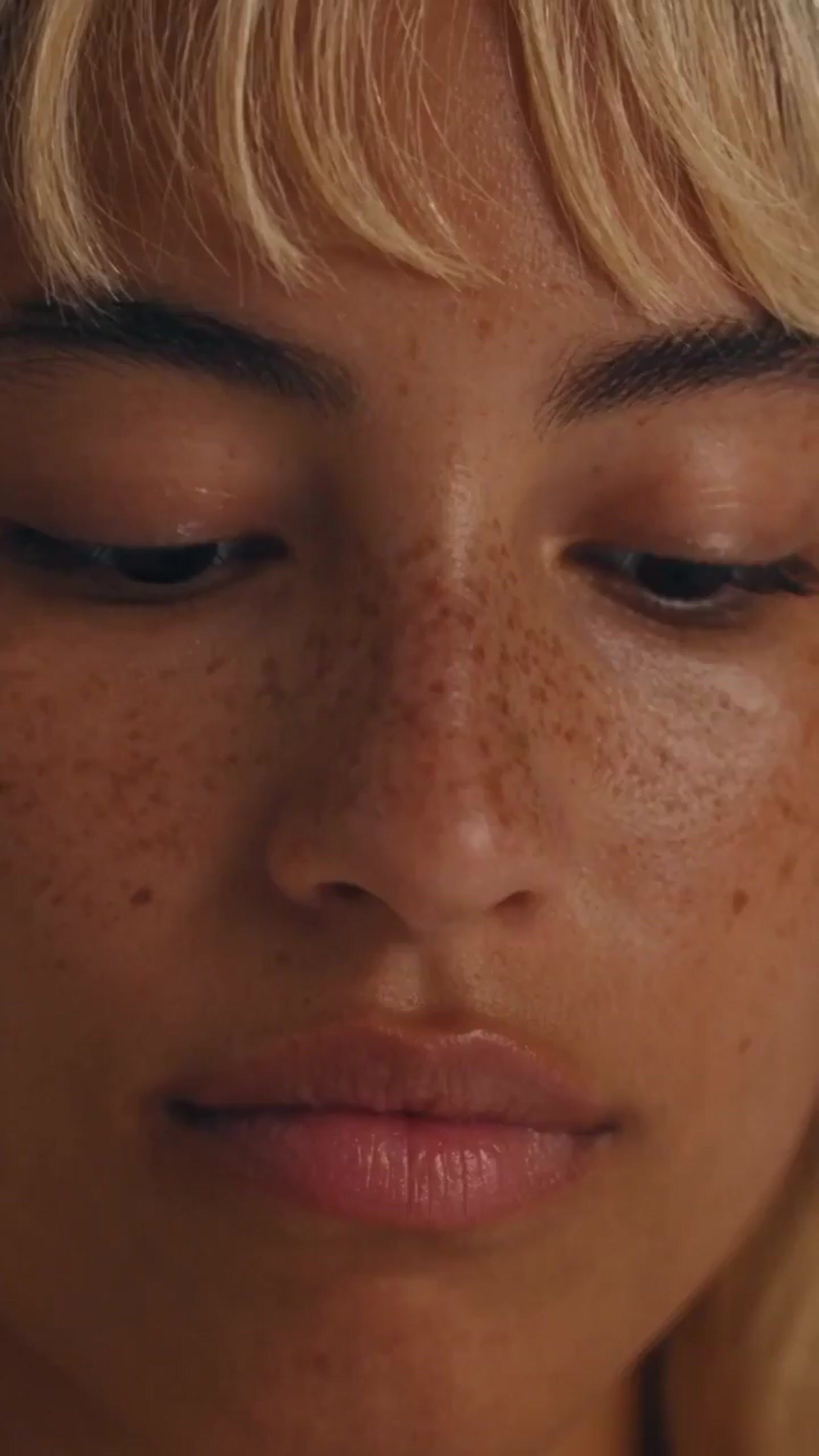 a close up of a woman with freckles on her face