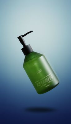 a green liquid bottle with a black pump