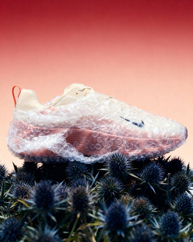 a shoe covered in plastic sitting on top of a plant