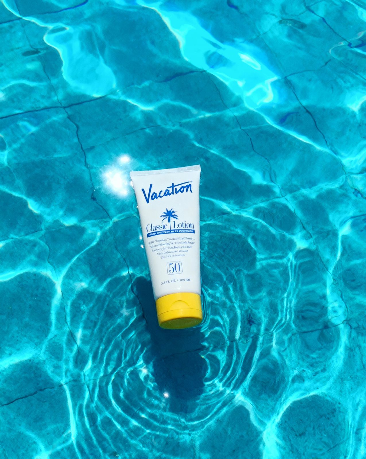 a tube of sunscreen sitting in a pool of water