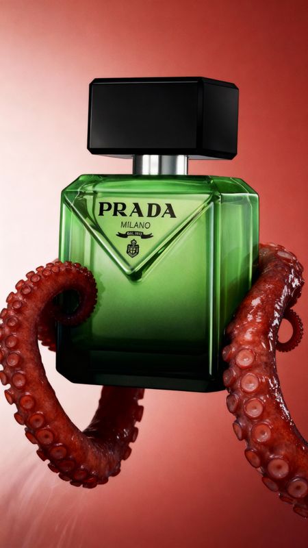 an octopus is holding a green bottle of prada