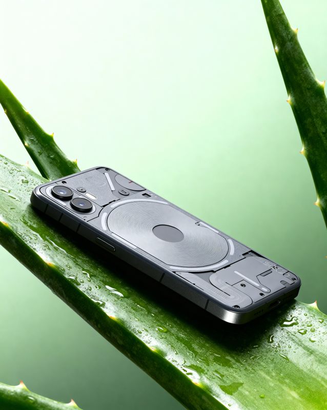 a cell phone sitting on top of a leaf