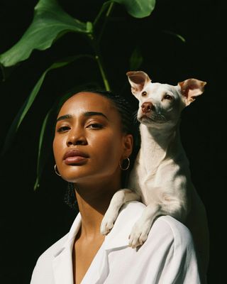 a woman holding a small dog in her arms