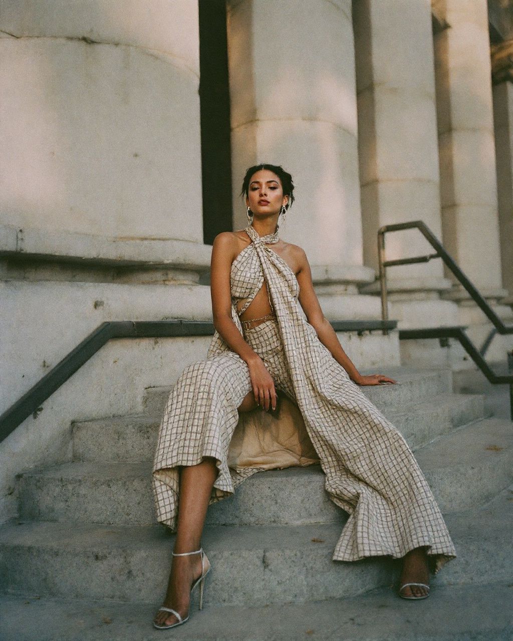 a woman is sitting on the steps of a building