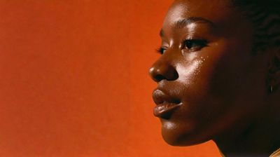 a close up of a person with a orange background