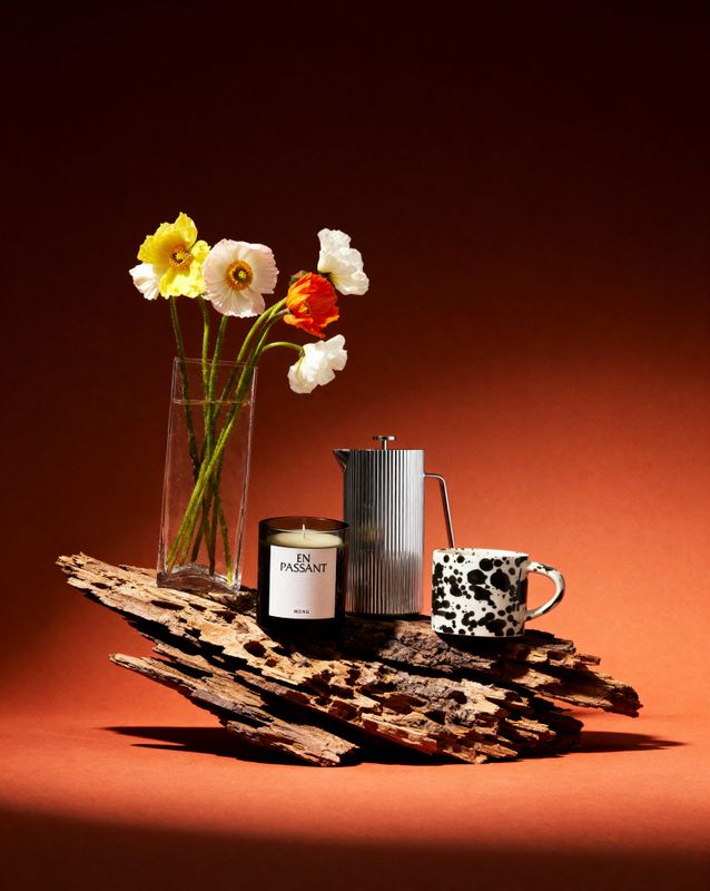 a vase of flowers sitting on top of a wooden table