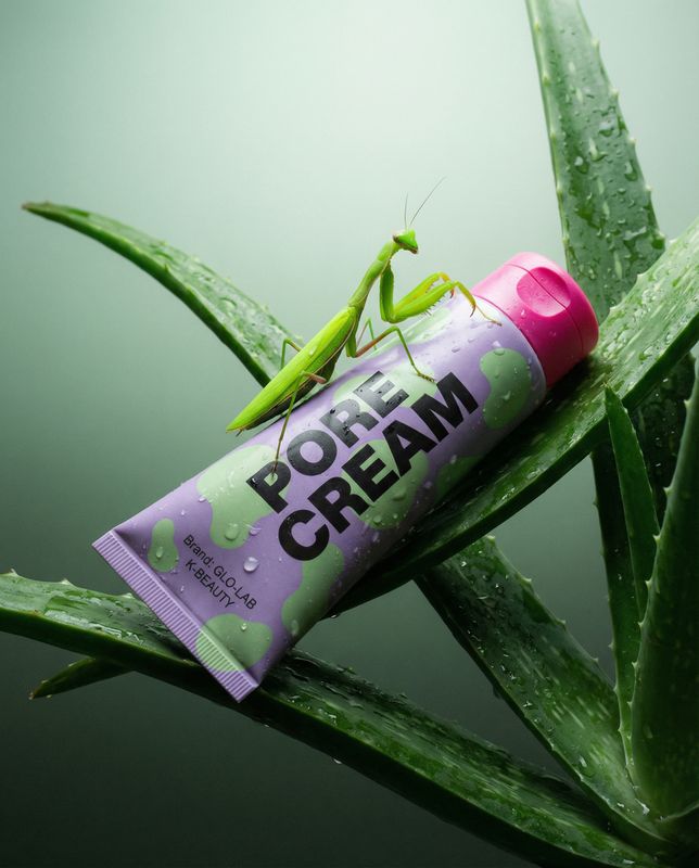 a close up of a tube of cream on a plant