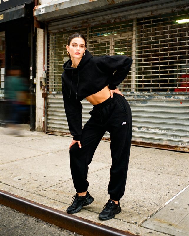 a woman standing on the side of a street